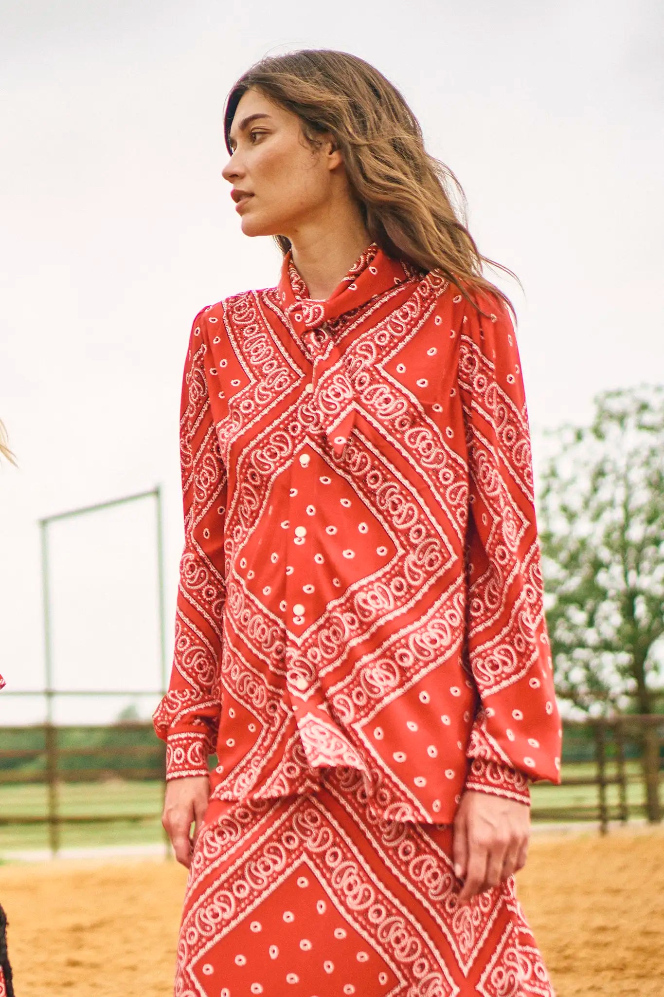 The Frances Top has a button front, long sleeves, button cuffs and a scarf collar detail.