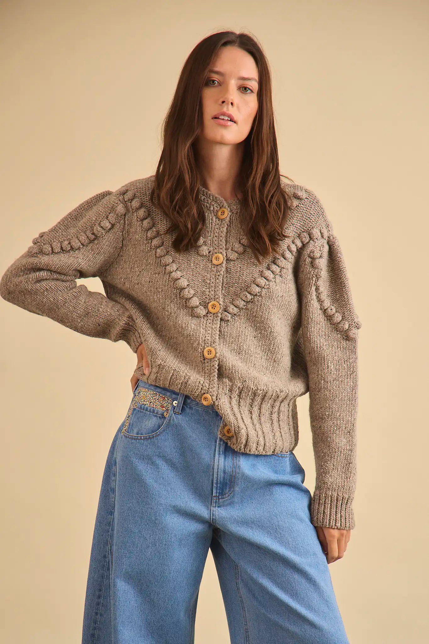 The Bobble Sweater is a crew neck style with a button-front, long sleeves and an oversized fit.