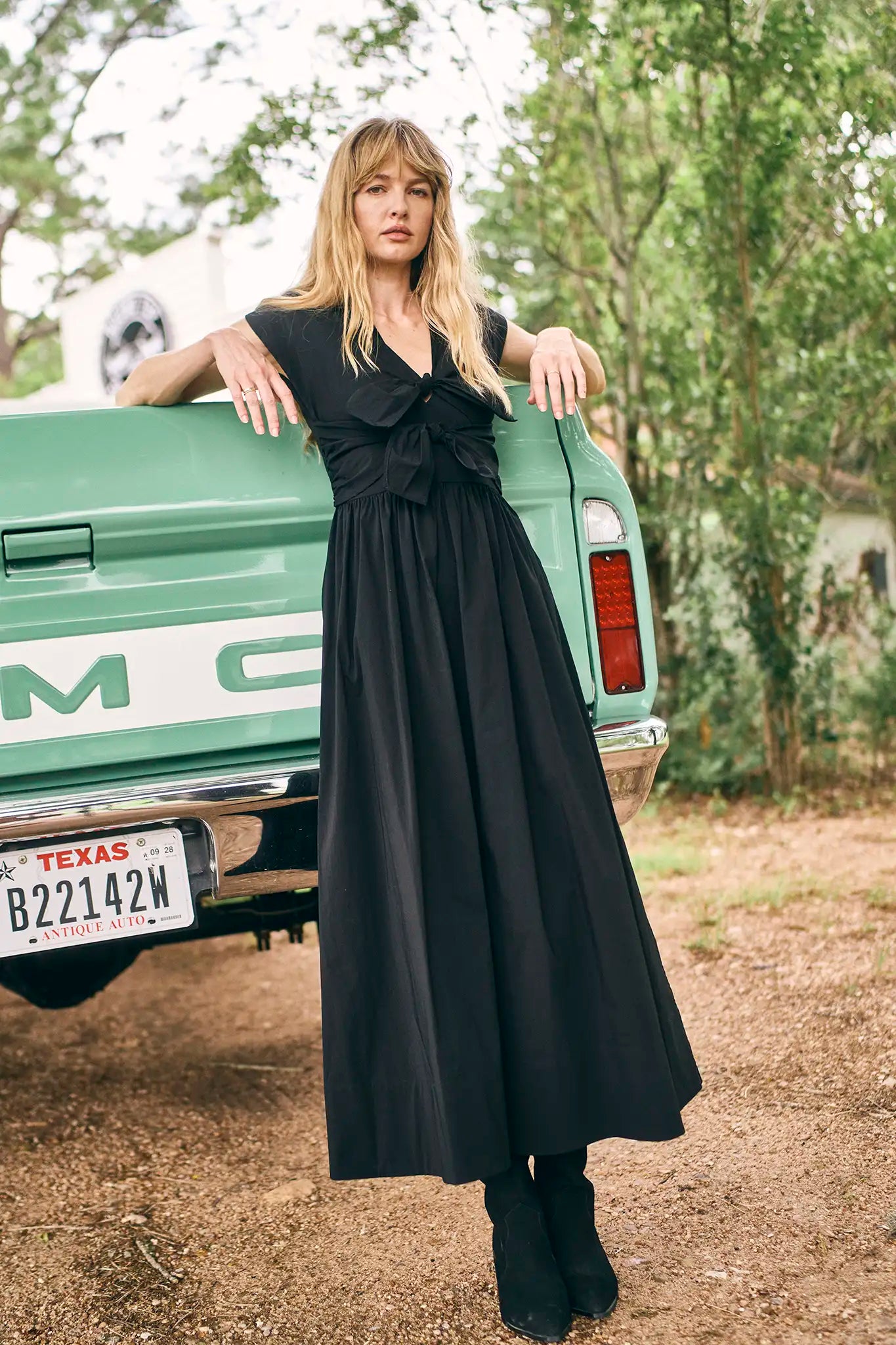 The Calista Dress has a V-neckline, cap sleeves, adjustable tie-front details and a full skirt.