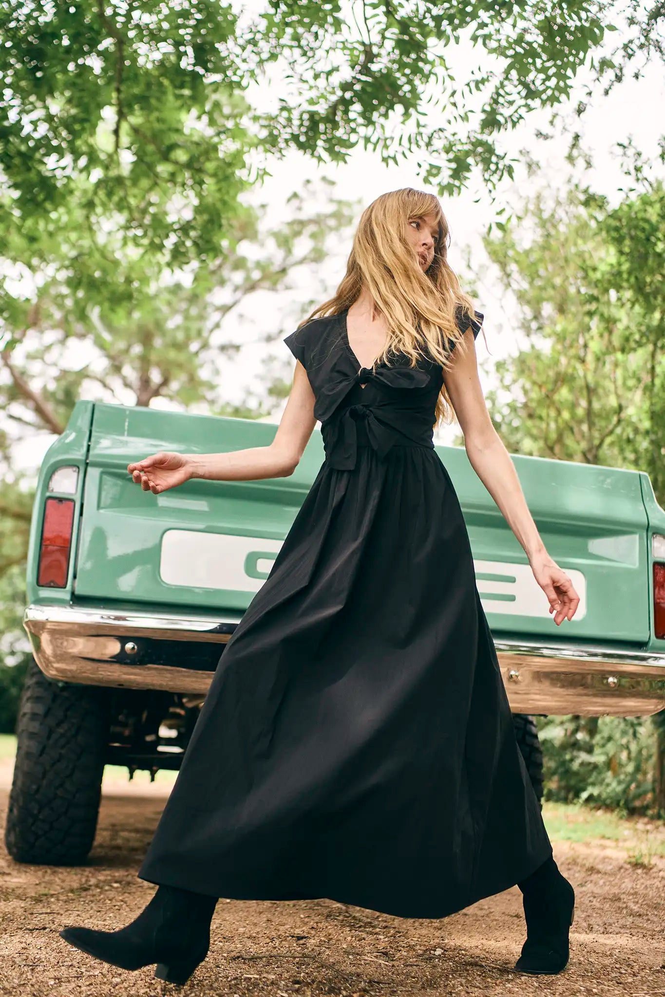 The Calista Dress has a V-neckline, cap sleeves, adjustable tie-front details and a full skirt.