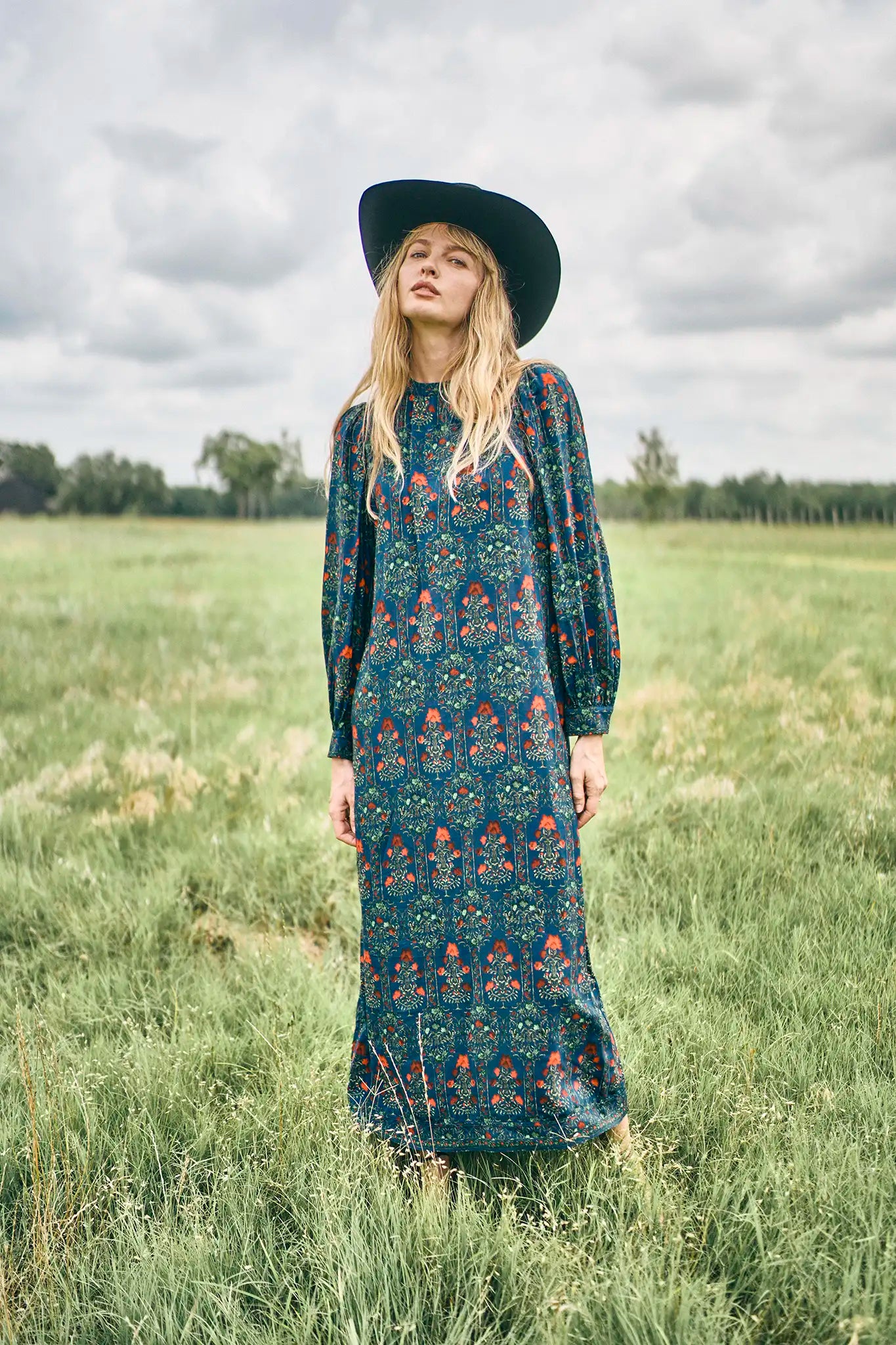 The Crosby Dress has a shirred round neckline, long sleeves, banded cuffs, and straight, silhouette.