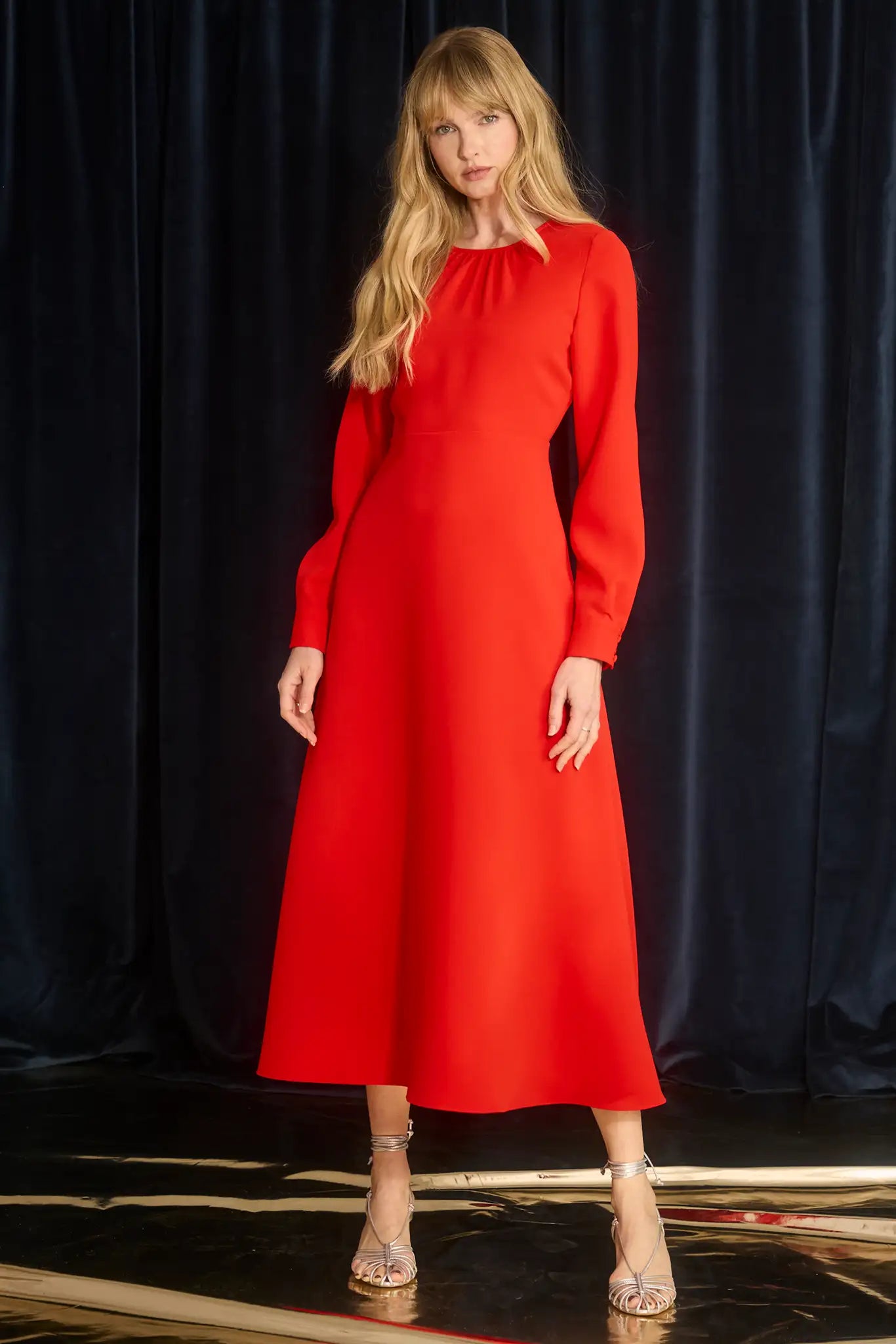 The Delancey Dress is long-sleeve with a shirred round neckline, banded cuffs, and a full skirt.