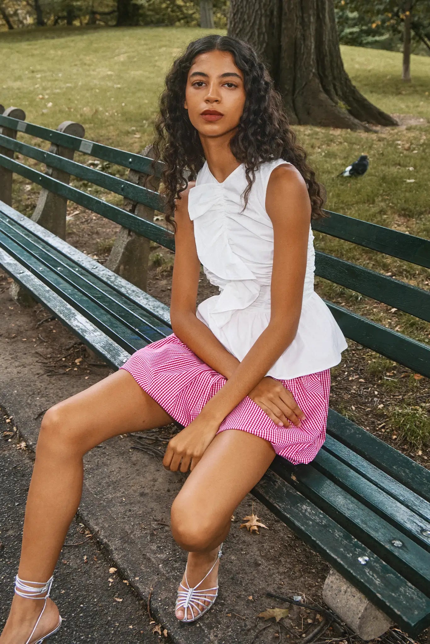 The Doering Top is a fitted V-neck silhouette with ruffles, shirring, and a peplum waist.