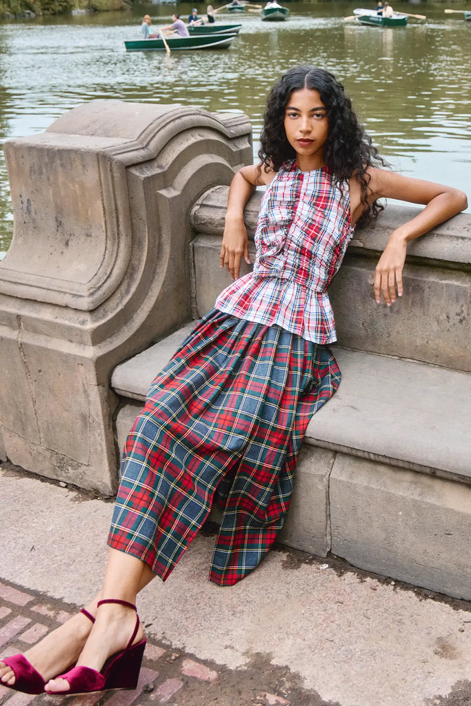 The Dominic Skirt has a banded waist and a straight pleated silhouette finished with front slits.