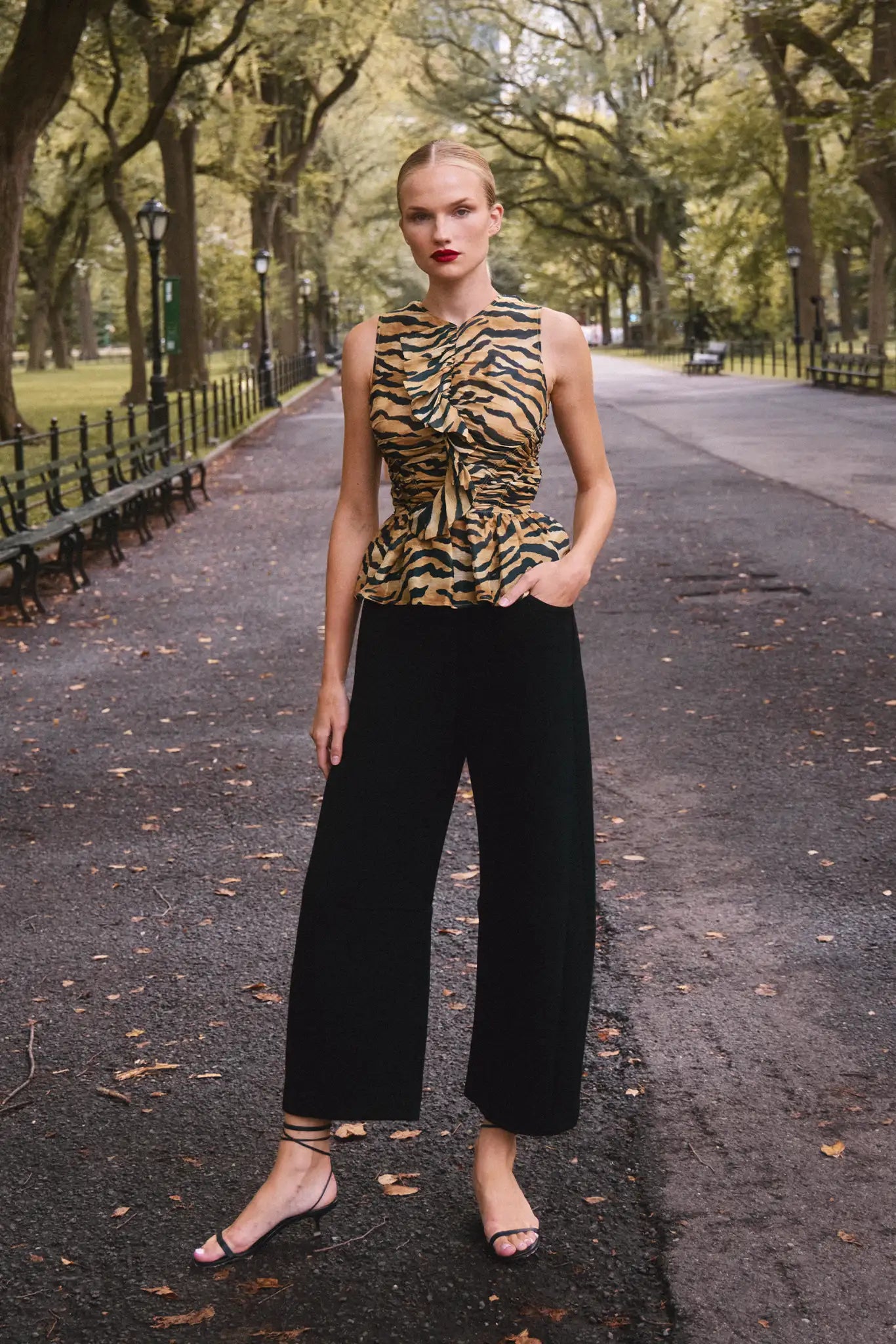 The Doering Top is a fitted V-neck silhouette with ruffles, shirring, and a peplum waist.