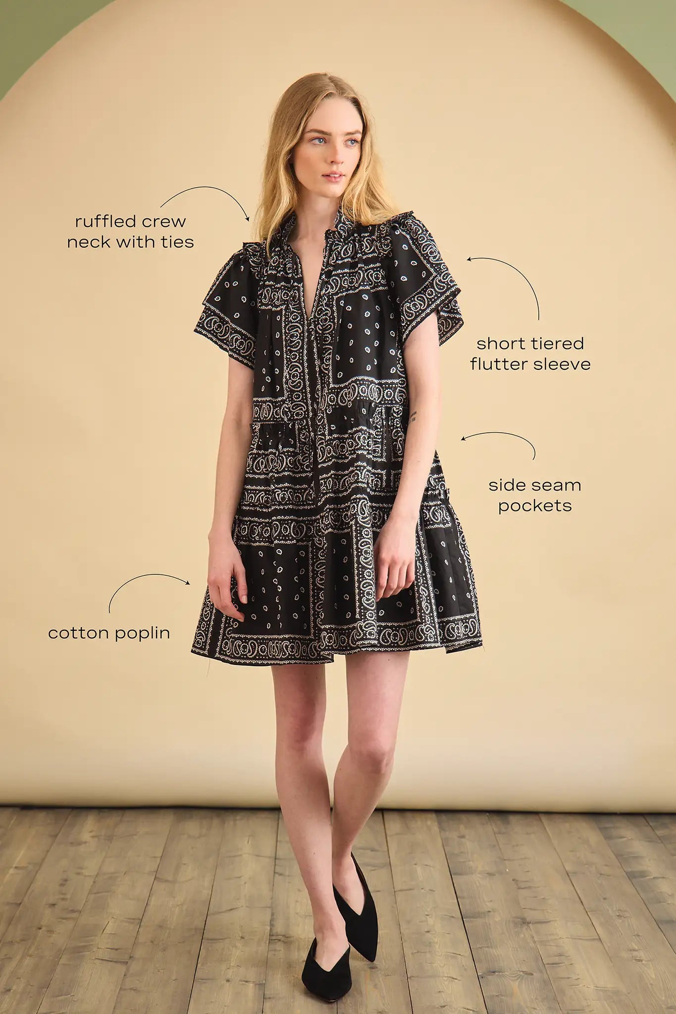 The Merritt Dress has a swing silhouette, ruffle detailing along the V-neck, and a tiered bodice.