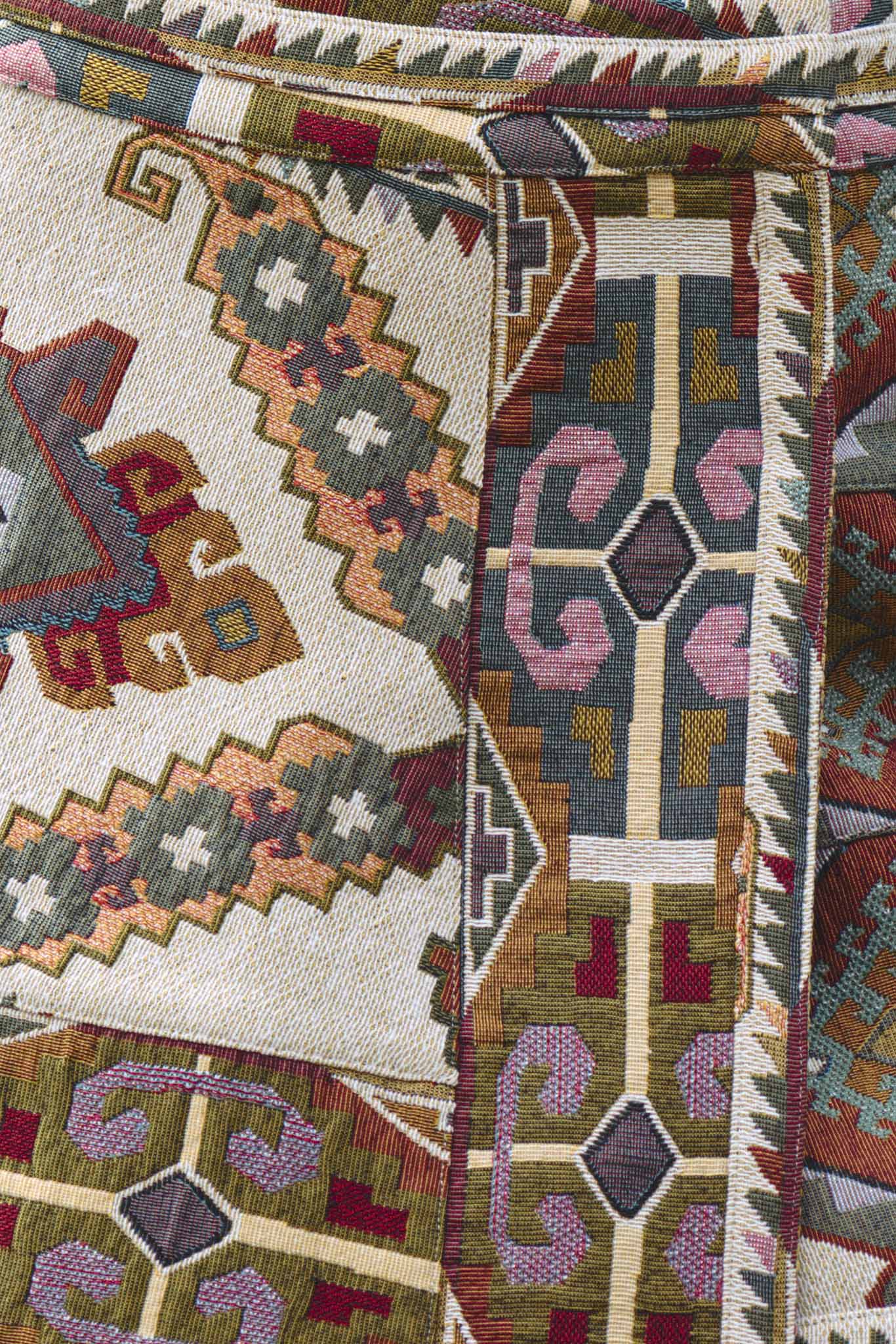 The Powell tapestry mini skirt has A banded waist and elegant wrap silhouette.