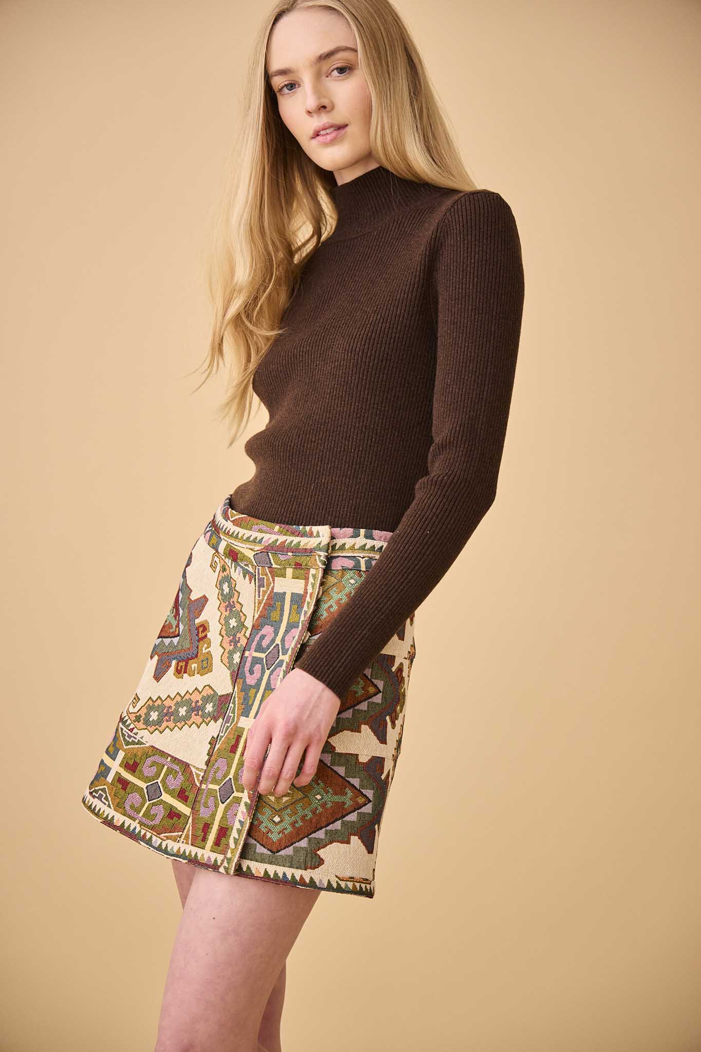 The Powell tapestry mini skirt has A banded waist and elegant wrap silhouette.