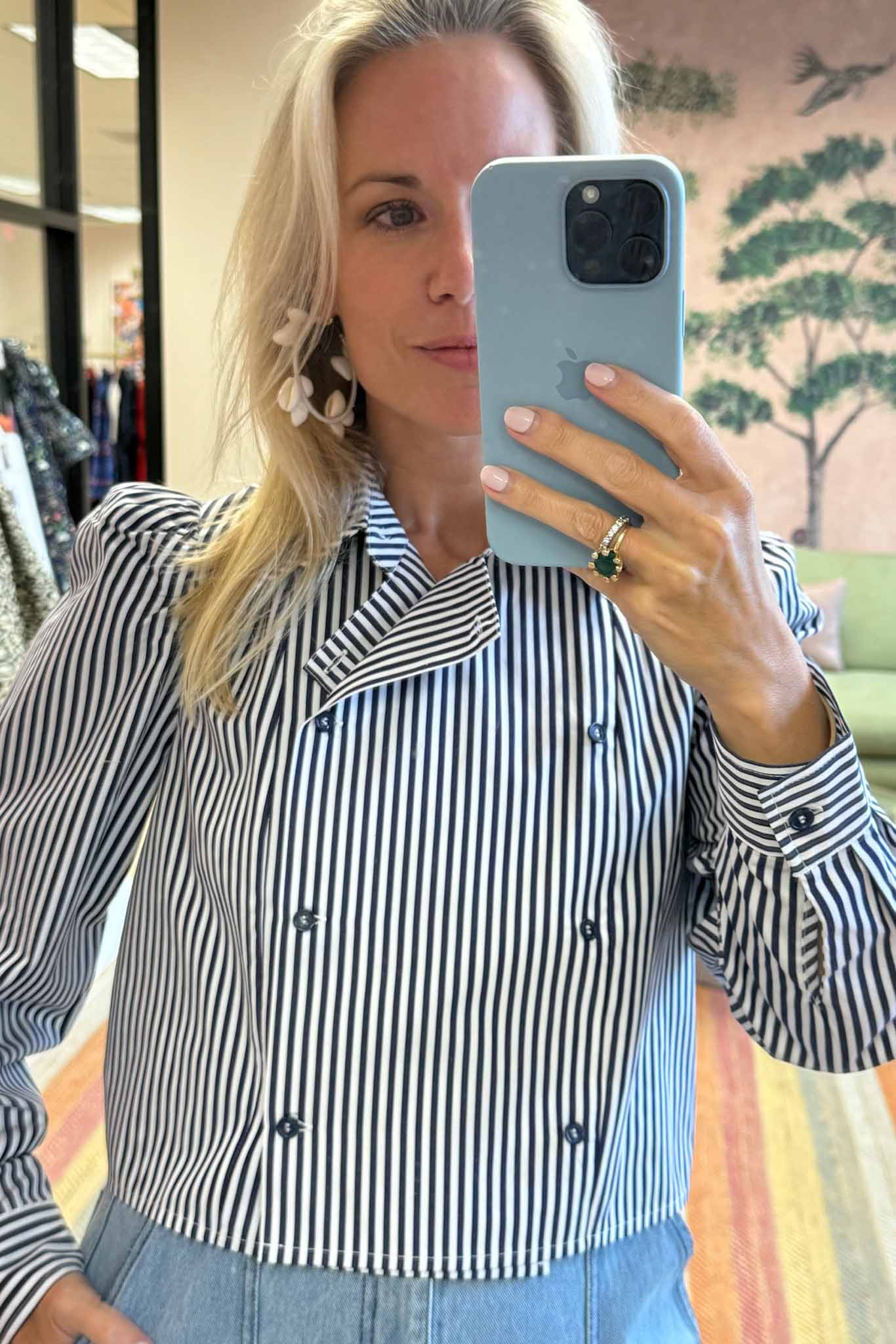 The cropped Annette Shirt is a striped long-sleeve with a double-breasted button placket.