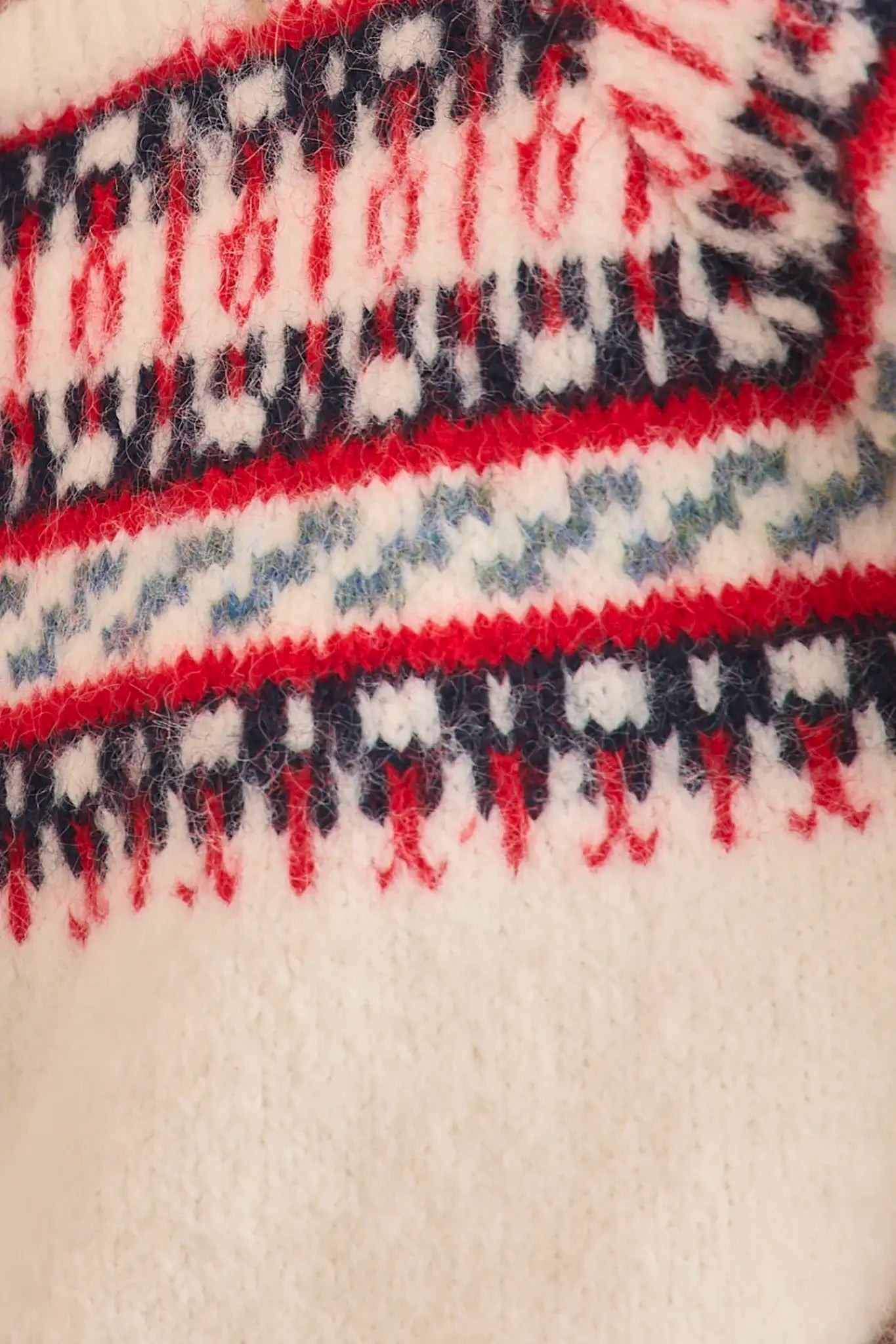 The Josie Sweater in Cream Fairisle has a ribbed crew neckline and long raglan sleeves.