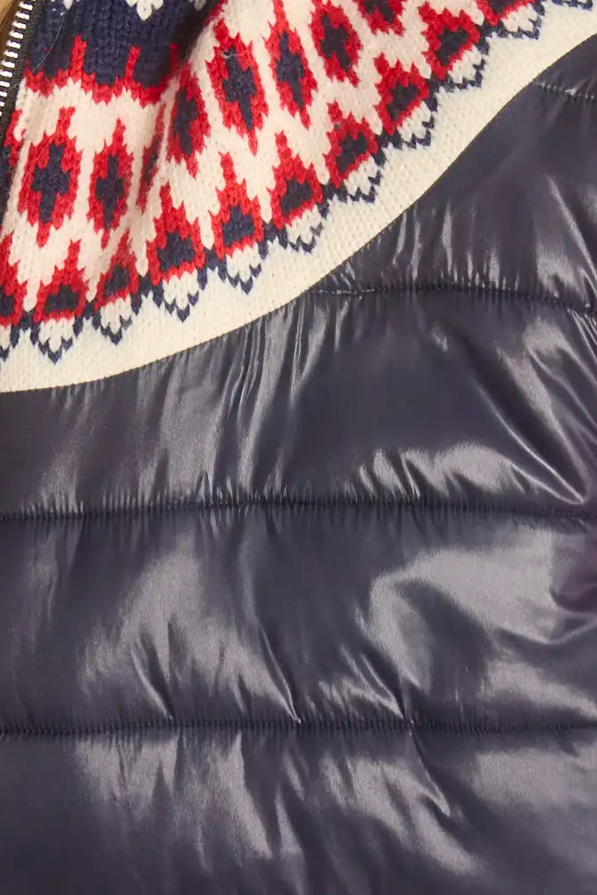The Brady Vest is a elevated puffer with a collared neckline and a knitted Fair Isle yoke.