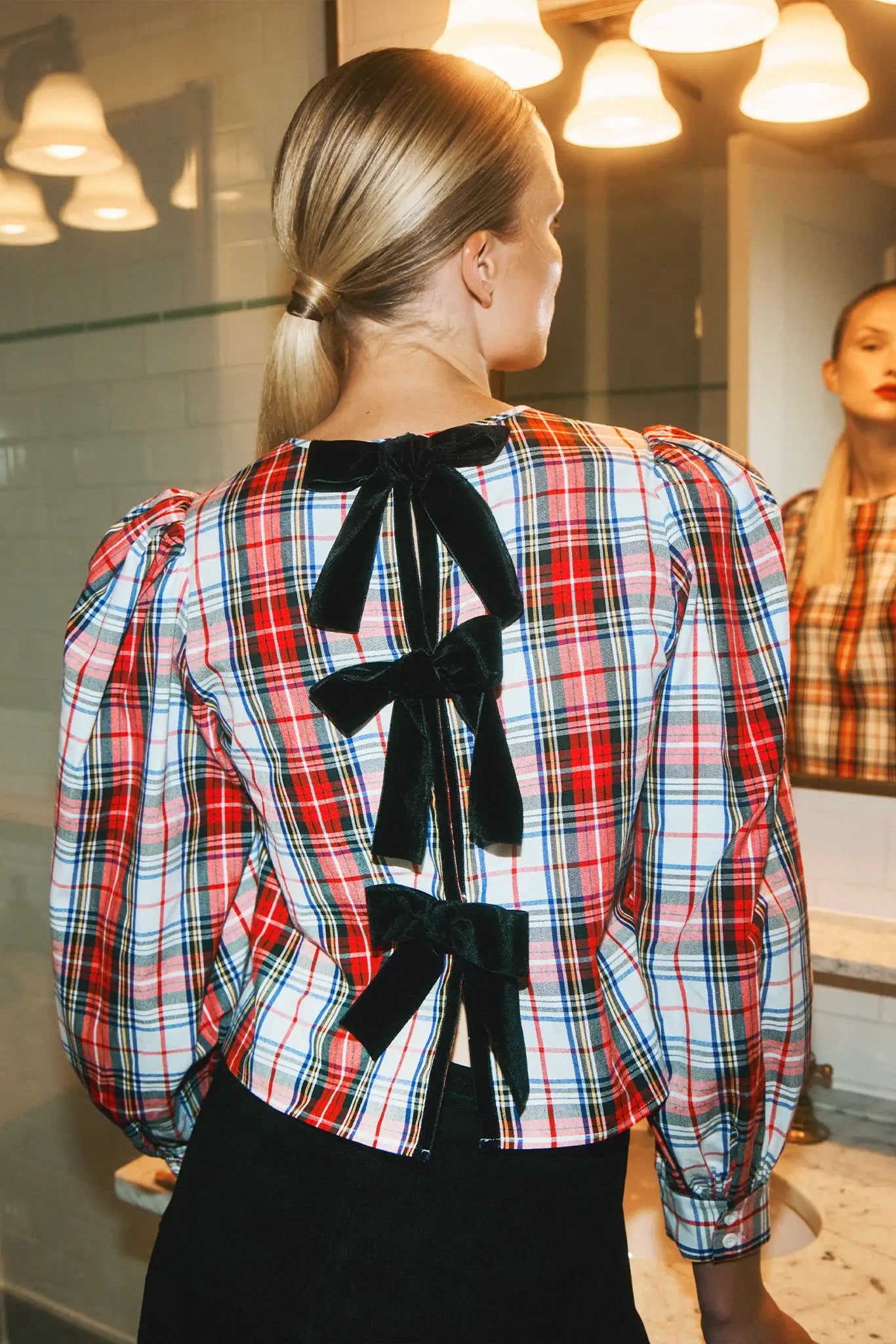 The Lottie Top has a crew neckline, black velvet ribbon ties, balloon sleeves with tailored cuffs.