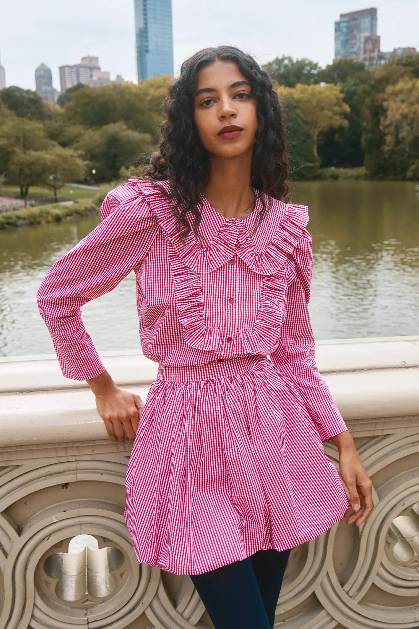 The Mae Top has a collared button front shape, ruffled yokes, and long sleeves with button cuffs.