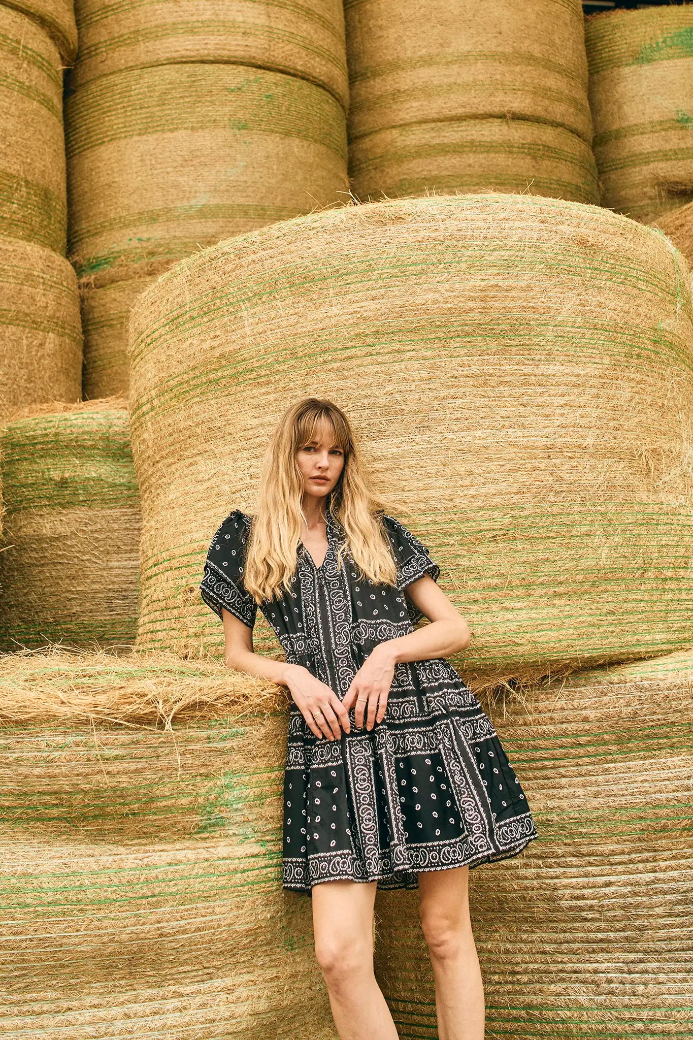 The Merritt Dress has a swing silhouette, ruffle detailing along the V-neck, and a tiered bodice.