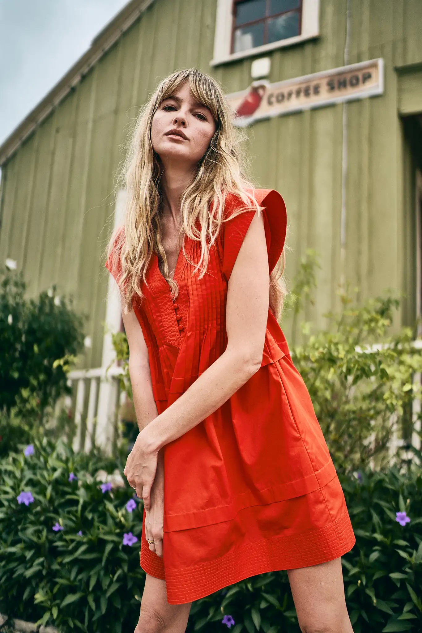 The Parker Dress has a V-neckline, front placket, banded cap sleeves, and side seam pockets.