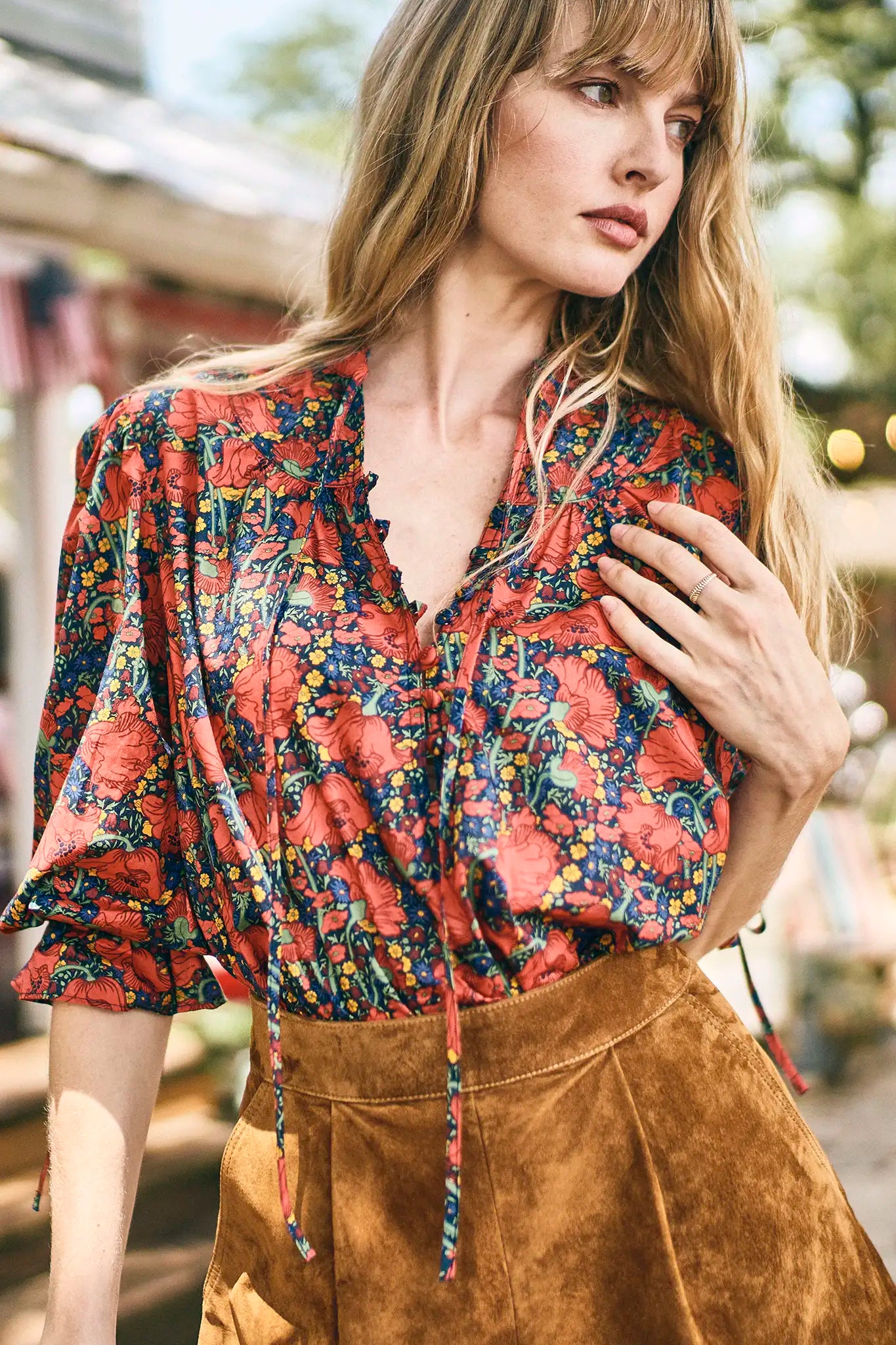 The Rory Top has a v-neckline, tie keyhole front with buttons, elbow-length sleeves with tie cuffs.