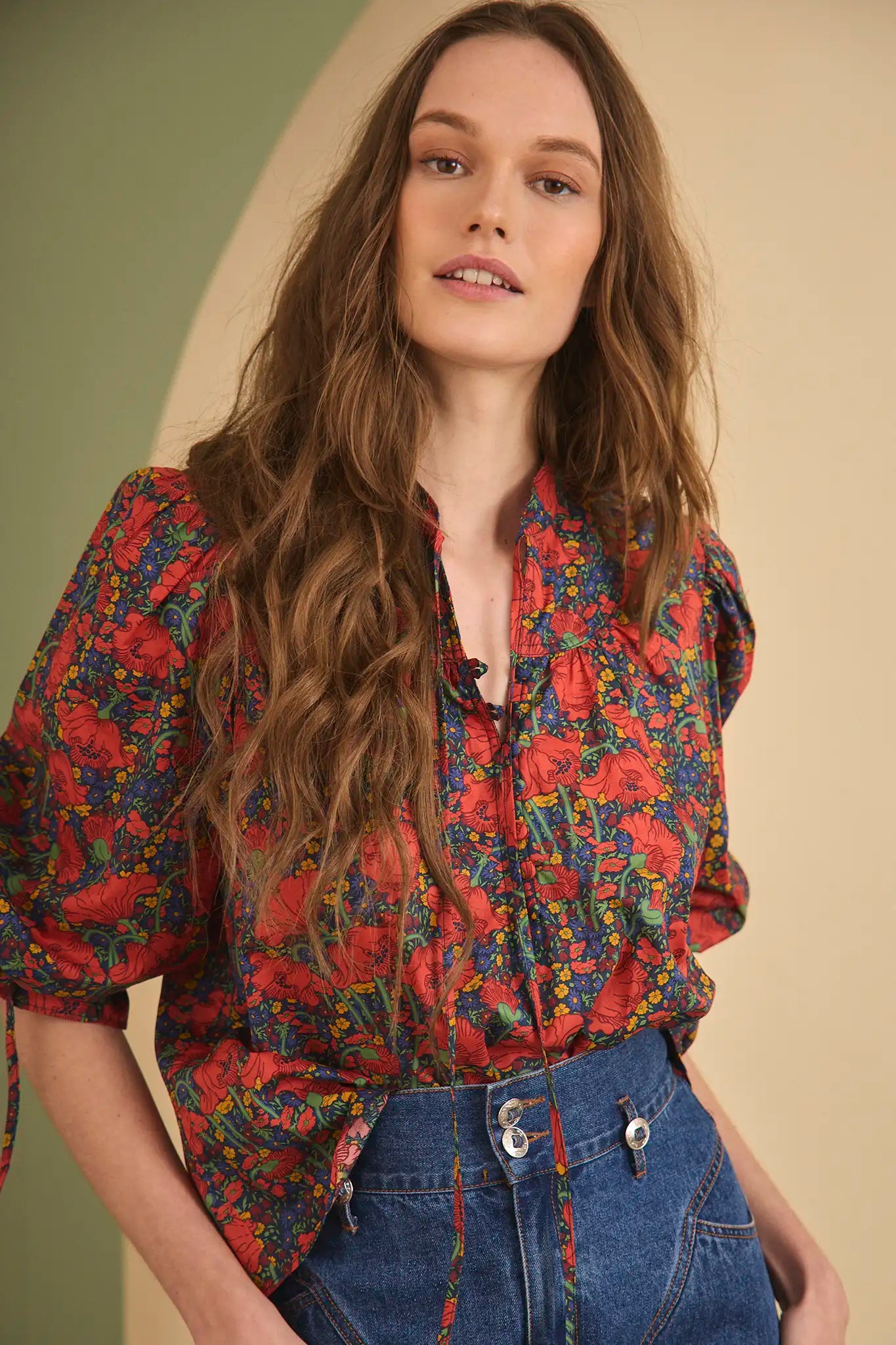 The Rory Top has a v-neckline, tie keyhole front with buttons, elbow-length sleeves with tie cuffs.