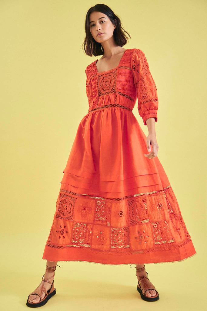 The Rowe dress has crochet lace at the bodice, skirt, sleeves, and a square neck and bobble trim.