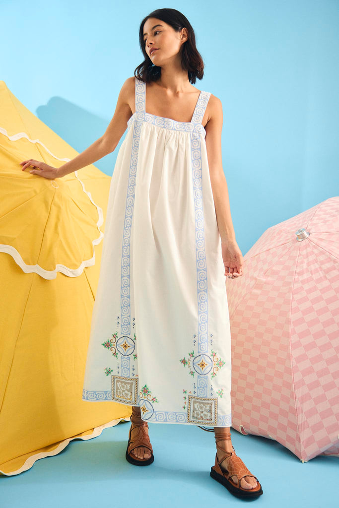 The Sailor dress features apron-style straps and intricate embroidery with a relaxed fit.