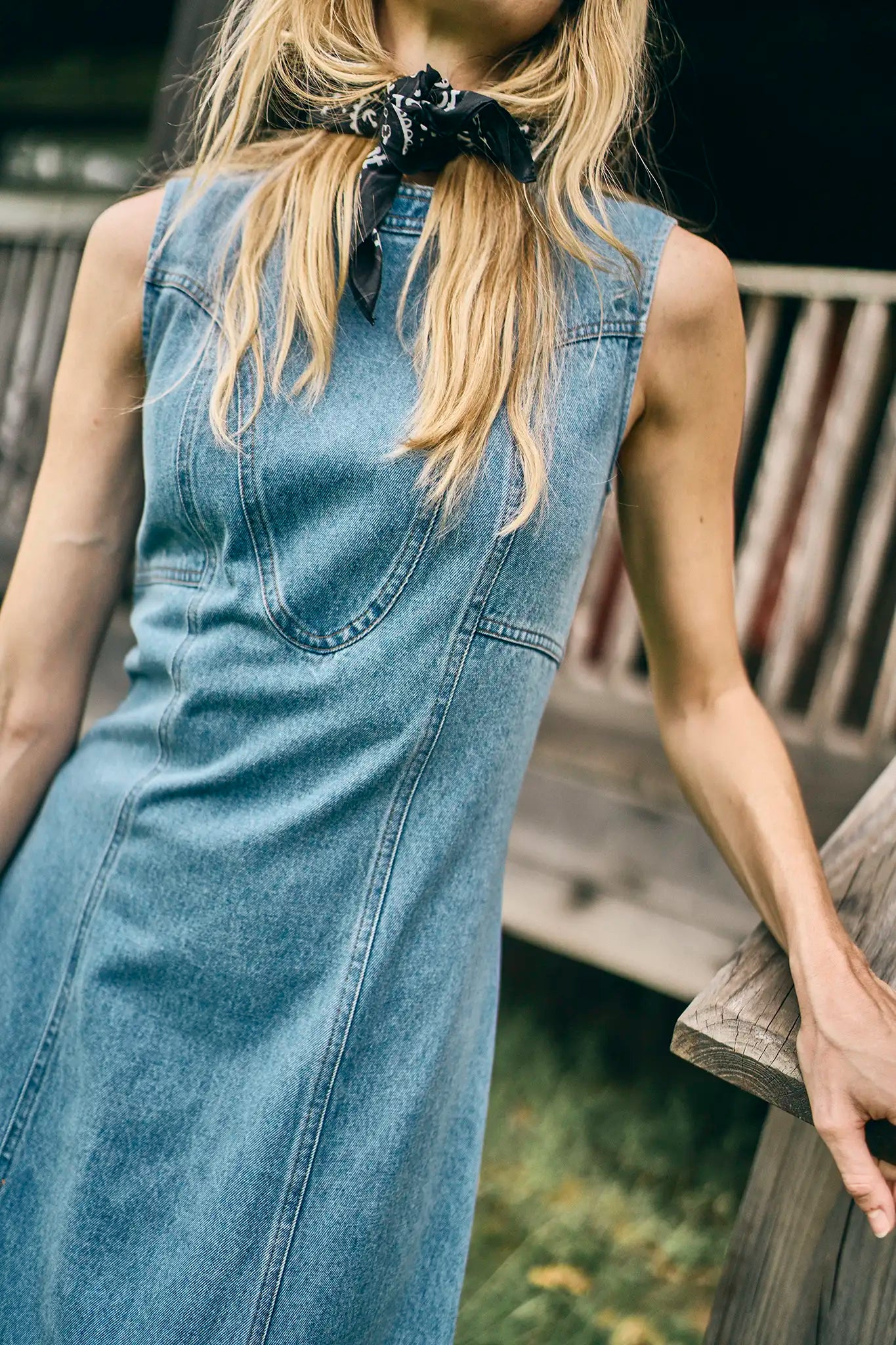 The Sedona Dress has a sleeveless crew neck, detailed seaming, a fitted bodice, and kick pleats.