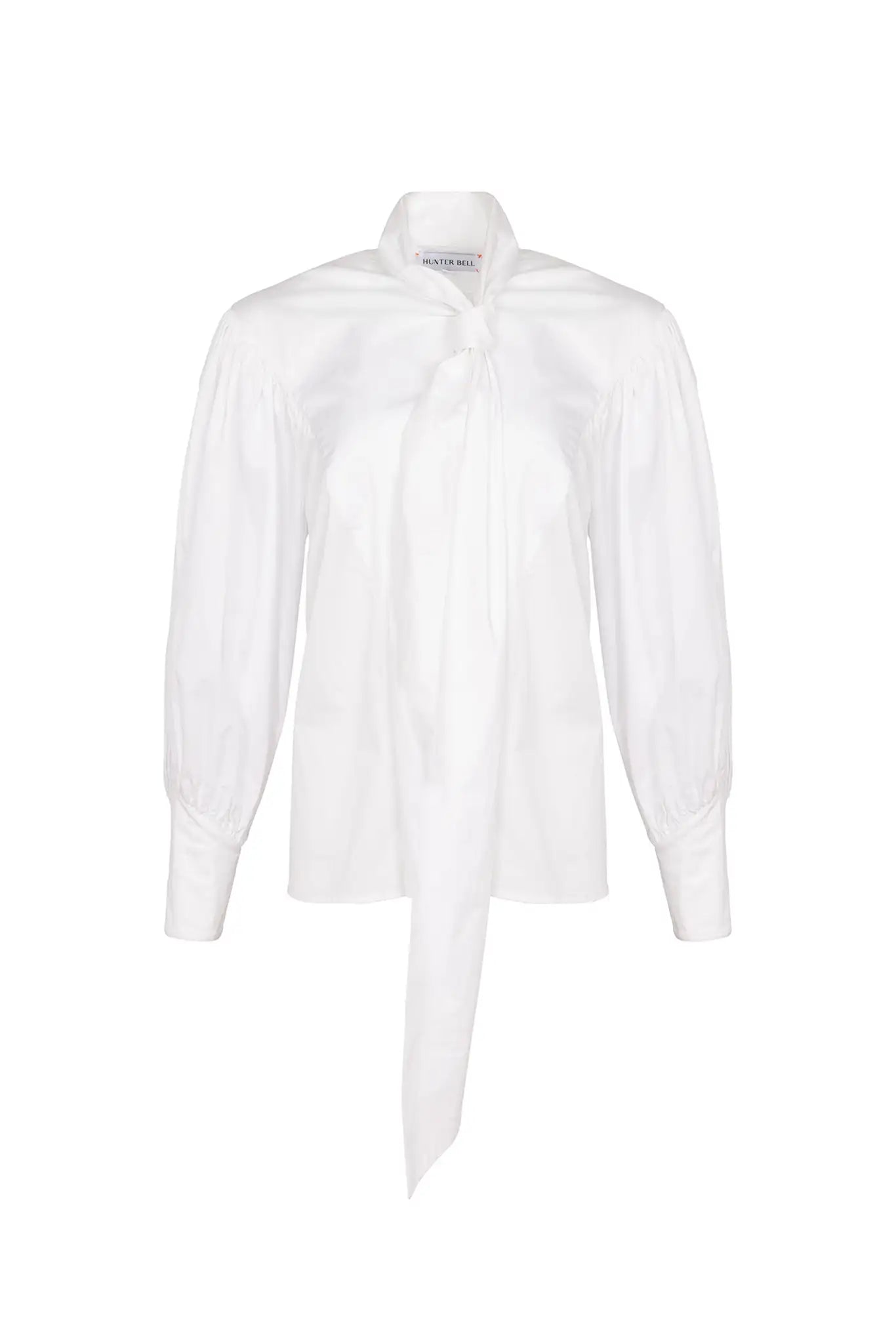 The Shay Blouse is designed with a tie-front neckline and long sleeves with angled button cuffs