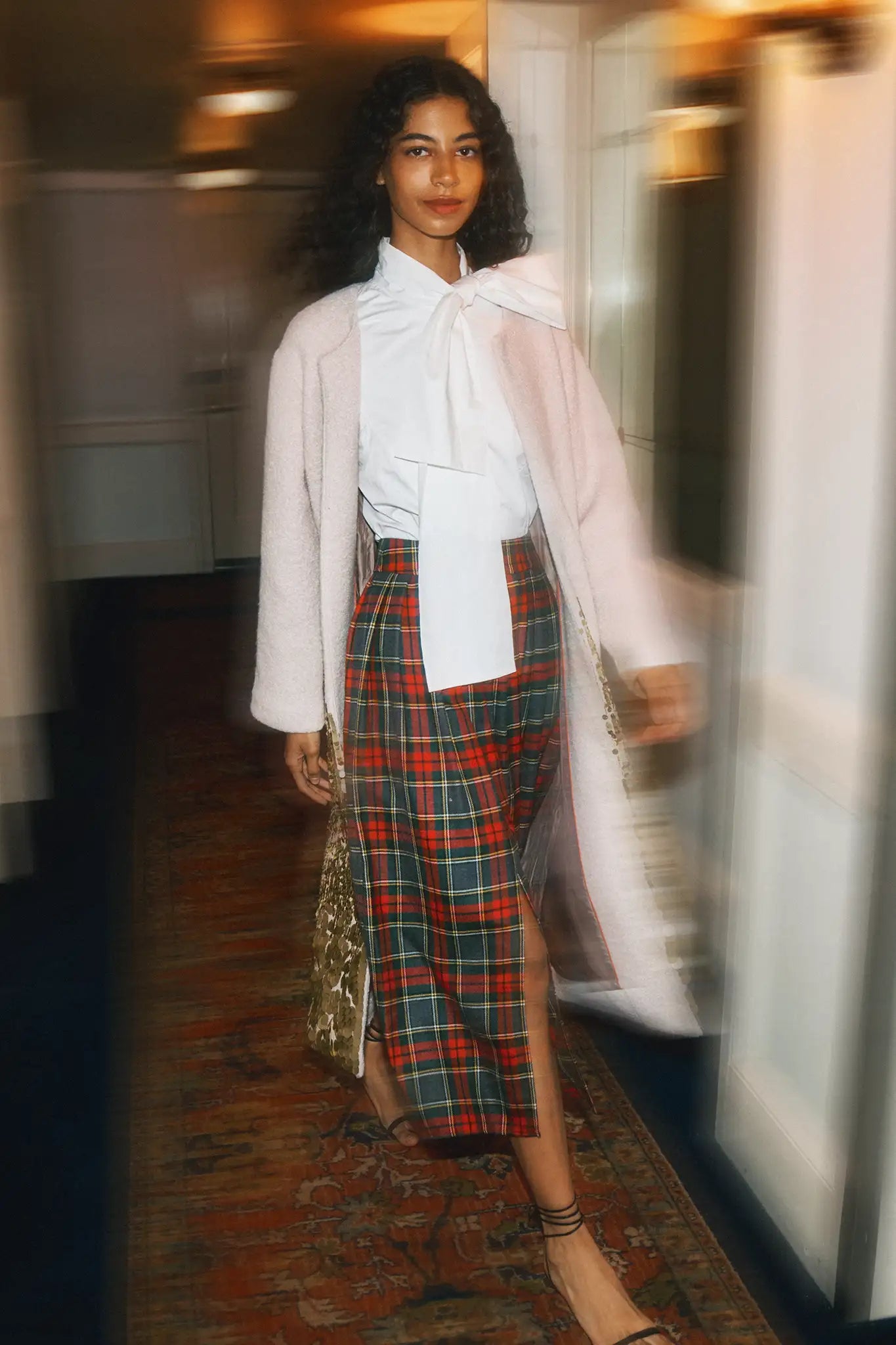 The Shay Blouse is designed with a tie-front neckline and long sleeves with angled button cuffs