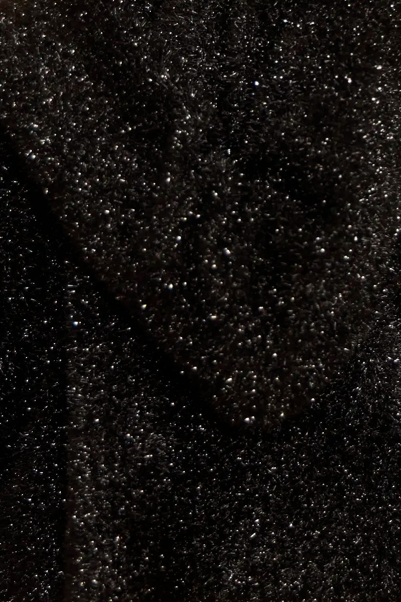 The turtleneck is made with shimmering yarn, oversized, long sleeves, and slightly cropped fit.