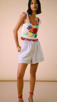 The Doris crochet top has a square neckline with a sleeveless design and a citrus motif appliqué.