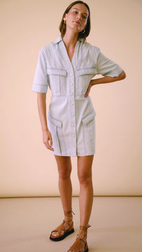 The Melanie denim mini dress is a straight silhouette, with snap buttons and large pockets.