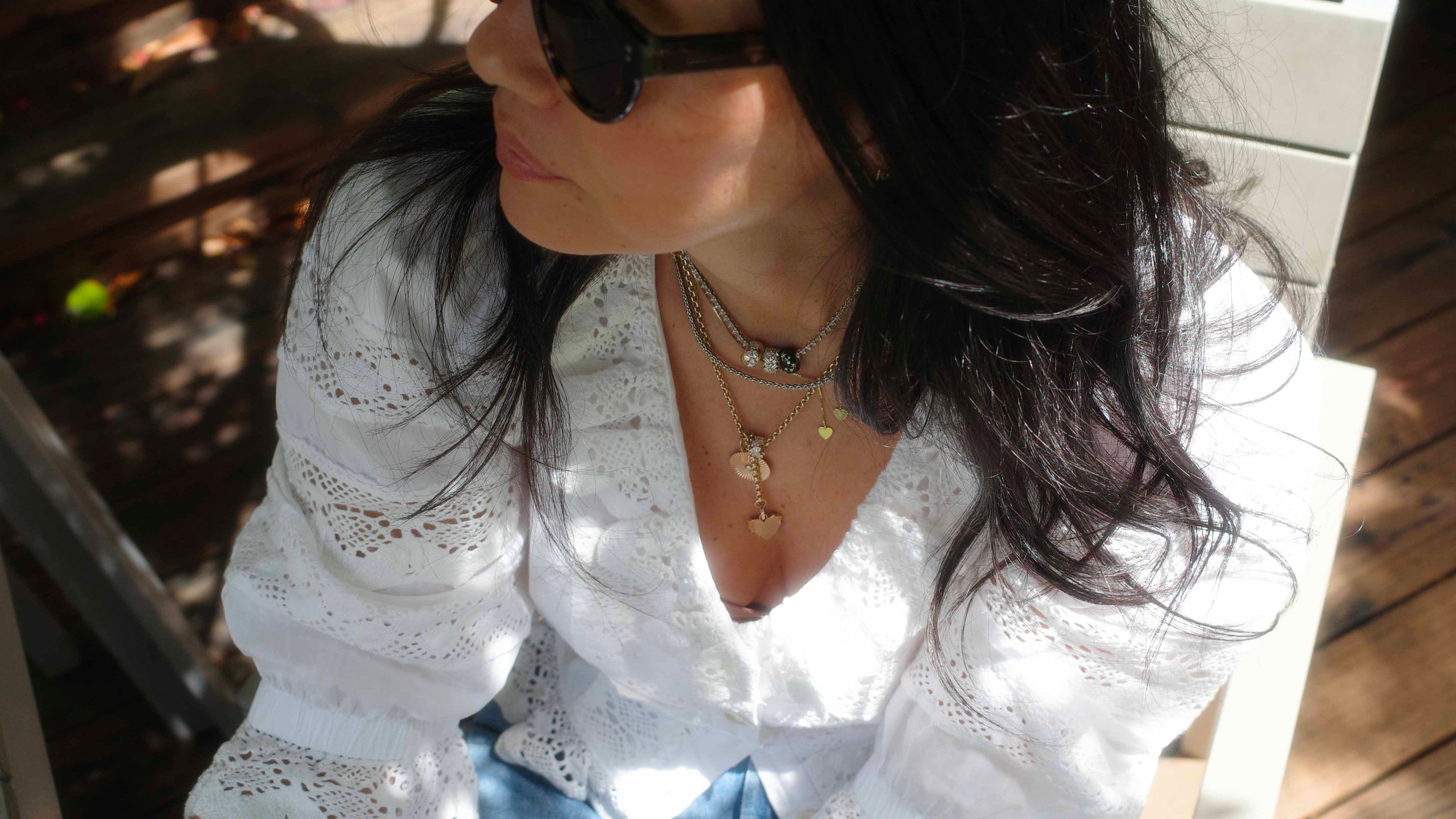 Meredith Peck in Hunter Bell Primrose Blouse, black sunglasses, fun jewelry, outside