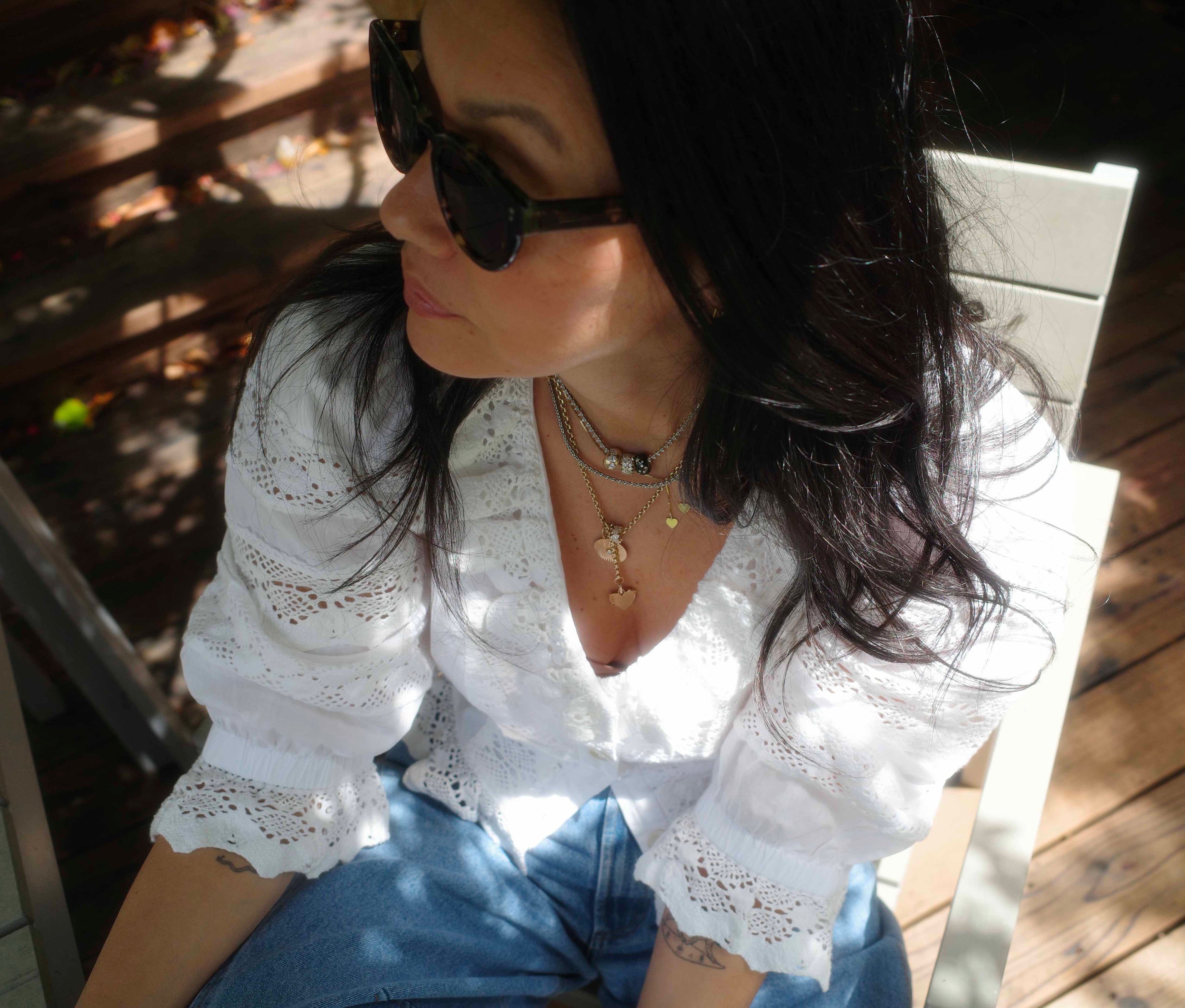 Meredith Peck in Hunter Bell Primrose Blouse, black sunglasses, fun jewelry, outside