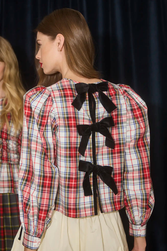 The Lottie Top has a crew neckline, black velvet ribbon ties, balloon sleeves with tailored cuffs.