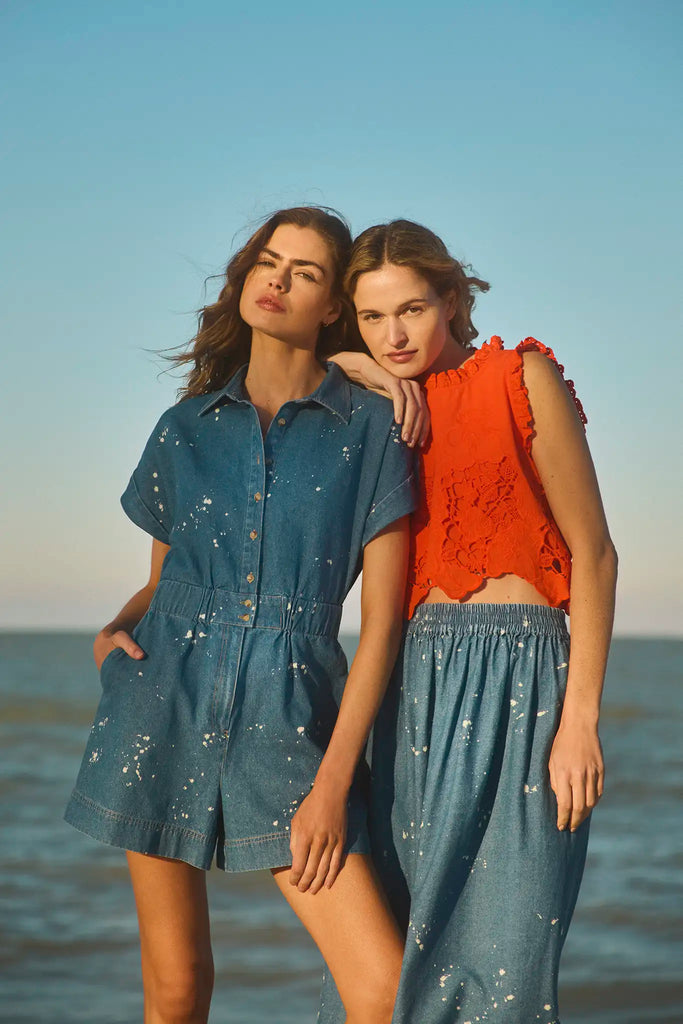 The Reed Romper has short sleeves, banded cuffs, an elastic waist, a button front and hip pockets.