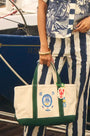 The medium canvas tote bag with green handles and fish motifs.