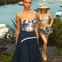 The Allegra Skirt in Navy paired with Nevis One Piece in Bermuda Toile in front of ocean. 