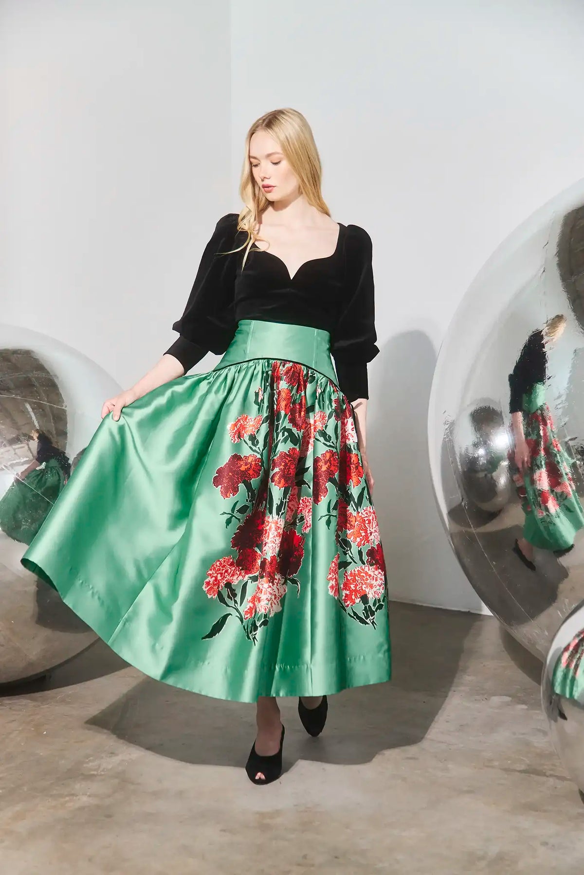 The Abrams Top in Velvet Onyx paired with the Nolita Skirt in Evergreen Conservatory. 
