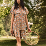 The Addison Dress, Made with Liberty Fabric floral dress, carrying a basket of florals.