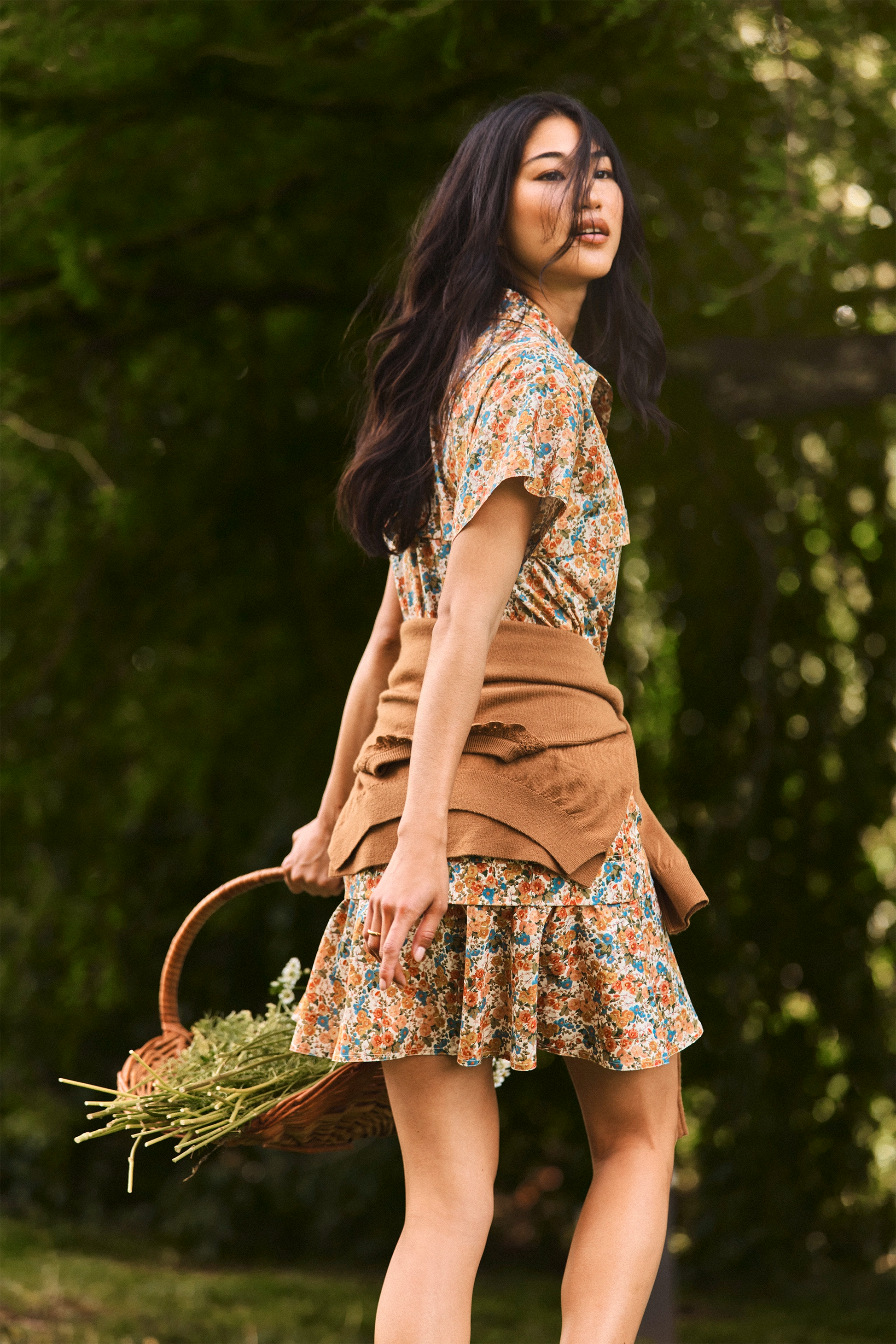The Addison Dress, Made with Liberty Fabric floral dress, carrying a basket of florals.