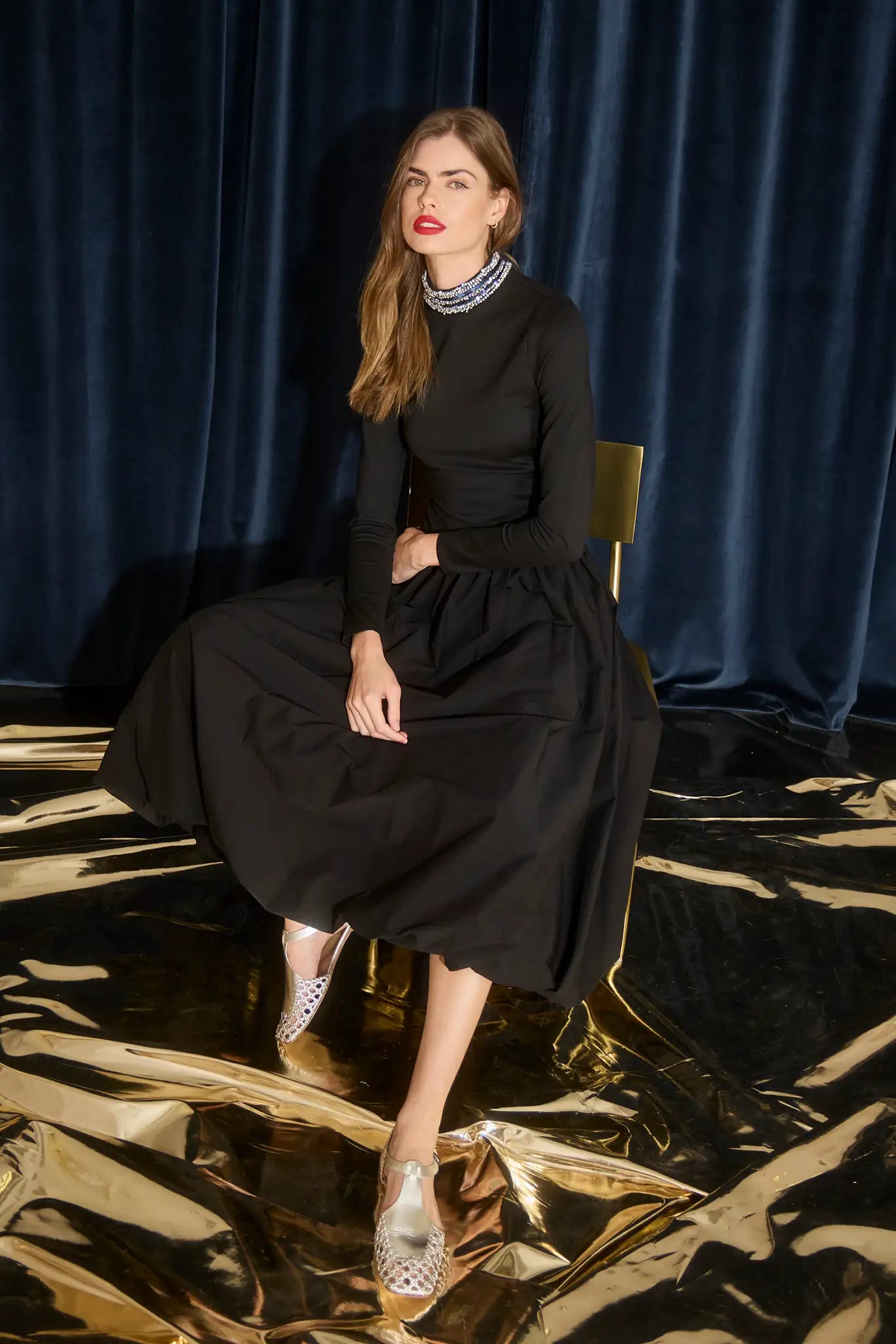 The Alexandra Dress is a fitted bodice with long sleeves, bubble skirt, and jeweled trim neckline. 