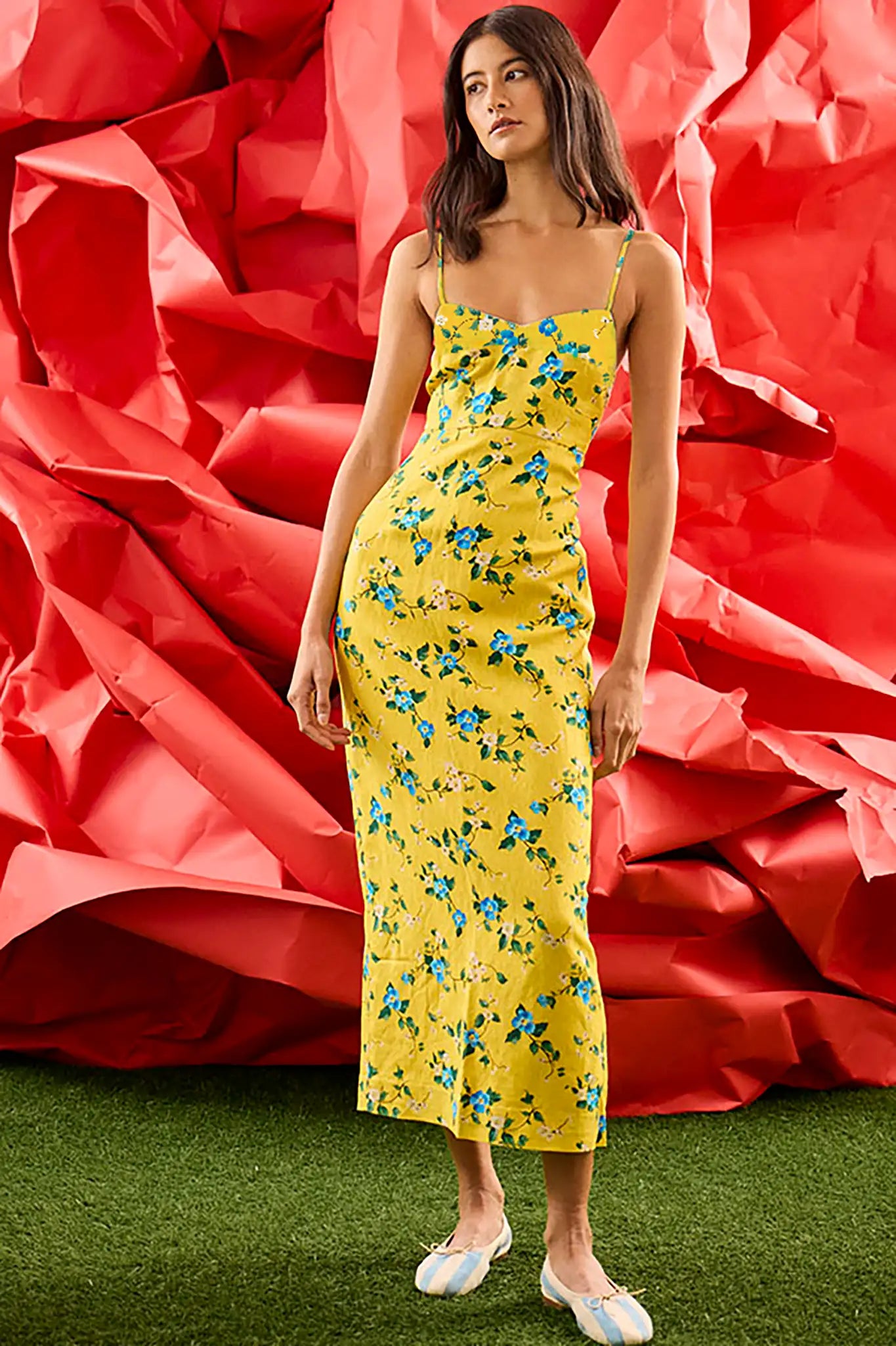 The Amal Dress in Middleton Meadow on model in front of red backdrop.