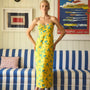 The Amal Dress in Middleton Meadow on model in front of red backdrop.
