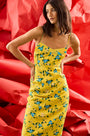 The Amal Dress in Middleton Meadow on model in front of red backdrop.