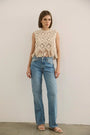 The Astor Top in cream paired with denim jeans.