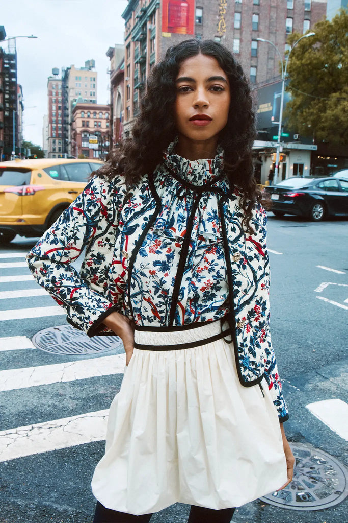 The Atwood Jacket is a quilted jacket with a crew neckline, long sleeves, and velvet ribbon trim.