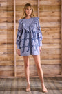 Blue cut-out embroidered linen, crew neckline, softly ruffled yoke, long sleeves with button cuffs