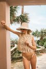 The Belize Bikini Bottom in coconut sand dot paired with cream fringe Astor Top and bucket hat.