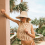 The Belize Bikini Bottom in coconut sand dot paired with cream fringe Astor Top and bucket hat.