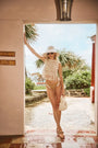 The Belize Bikini Bottom in coconut sand dot paired with cream fringe Astor Top and bucket hat.