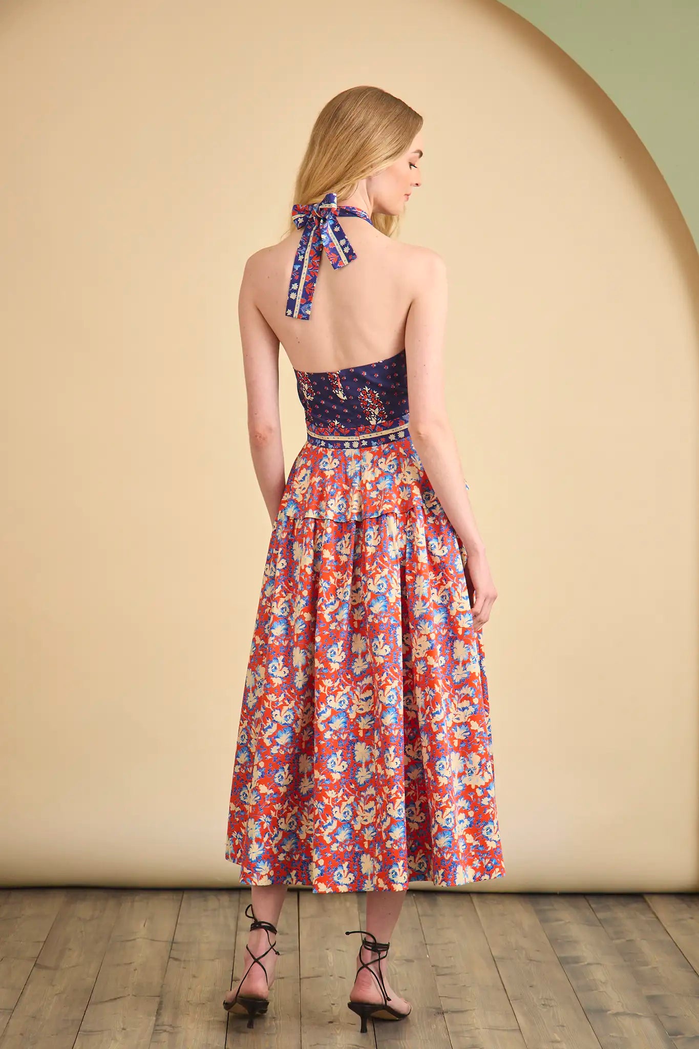 The Bellamy Dress is a criss cross halter dress with a full skirt and a clean side seam zipper.