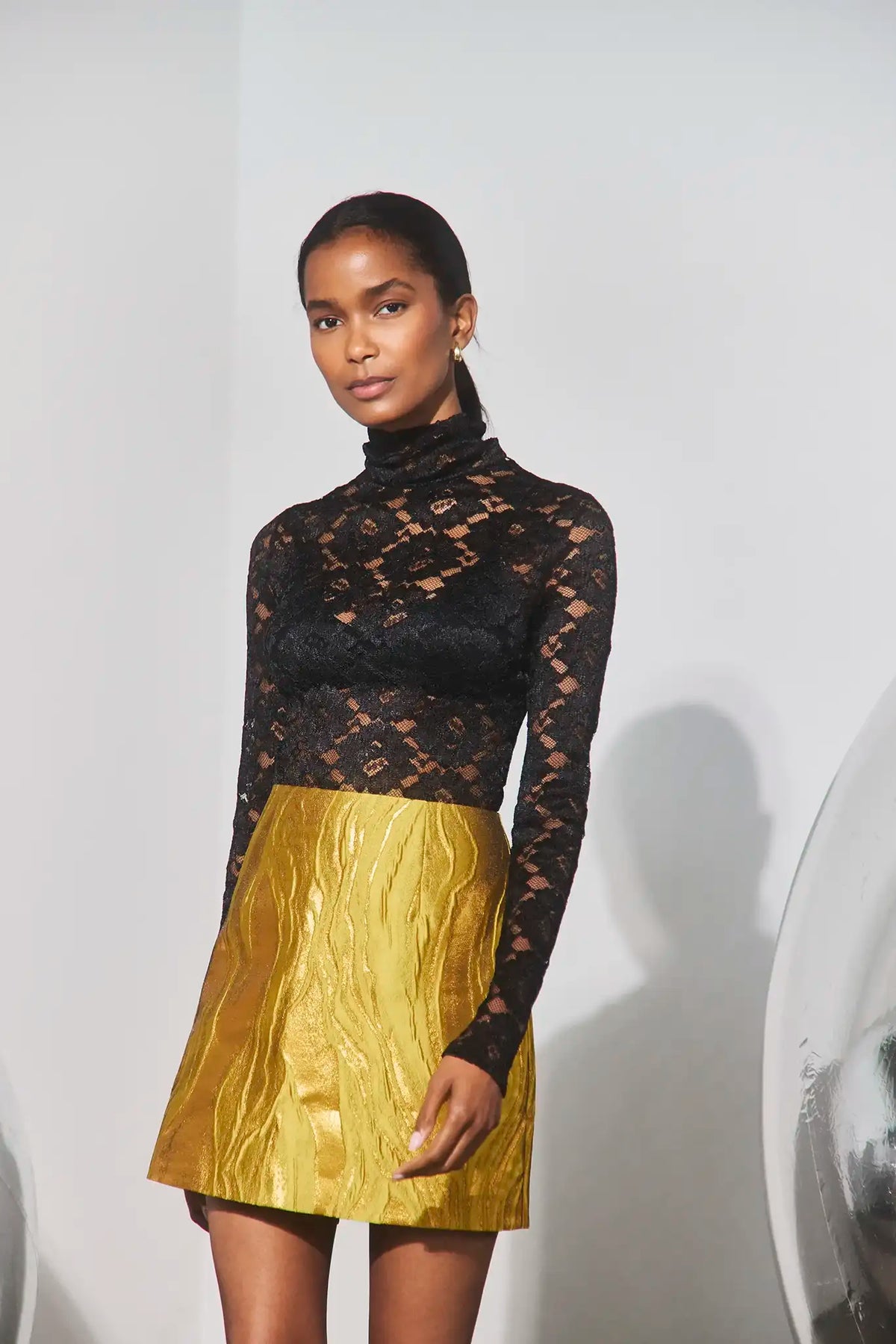 The Blaise Top in Noir Lace paired with the Britt Mini Skirt in Gilded Jacquard. 